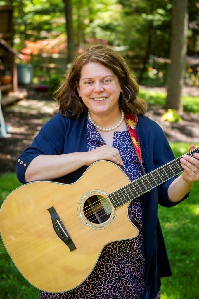 Image of Emily Howard Meyer with a guitar